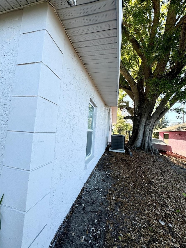 view of property exterior featuring central AC unit and stucco siding