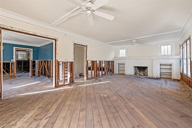 unfurnished living room with a brick fireplace, ceiling fan, ornamental molding, and wood-type flooring