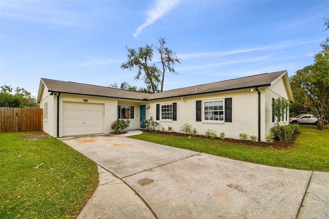 ranch-style home featuring a garage, concrete driveway, a front lawn, and brick siding