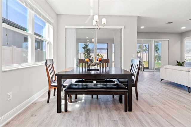 dining space with recessed lighting, visible vents, a chandelier, light wood-type flooring, and baseboards