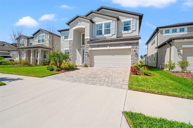 view of front of house featuring decorative driveway, stucco siding, a garage, a residential view, and stone siding