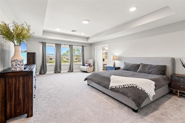 carpeted bedroom with a tray ceiling, recessed lighting, visible vents, a textured ceiling, and baseboards