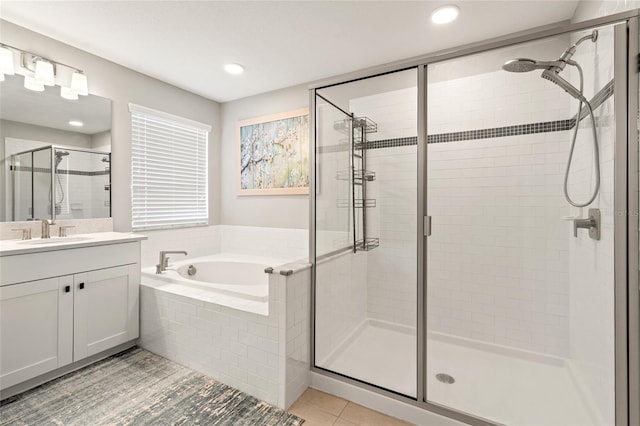 bathroom with a stall shower, recessed lighting, a bath, and vanity