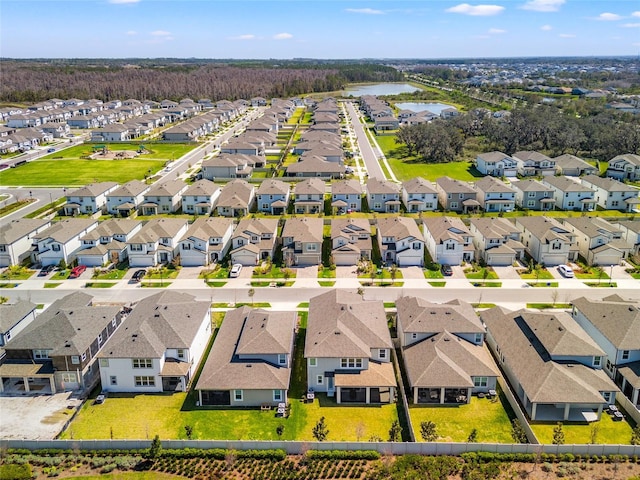 drone / aerial view with a water view and a residential view