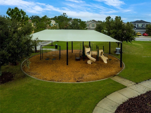 view of home's community with playground community and a lawn