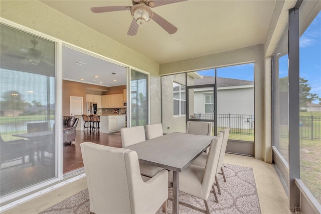 sunroom with ceiling fan