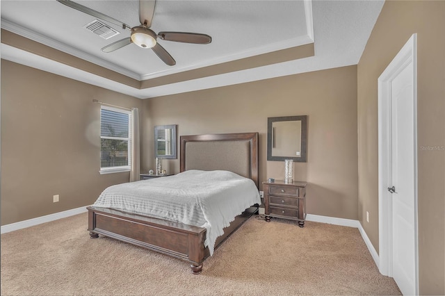 bedroom featuring light carpet, baseboards, visible vents, and a raised ceiling