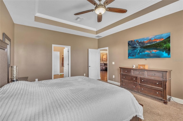 carpeted bedroom with baseboards, visible vents, and a raised ceiling