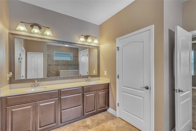 full bathroom with double vanity, a sink, and tile patterned floors