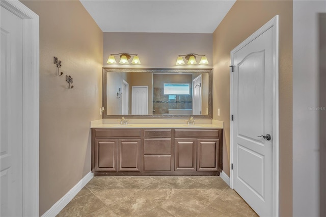 bathroom with a sink, baseboards, and double vanity