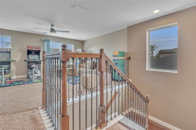 stairway with ceiling fan, baseboards, and recessed lighting