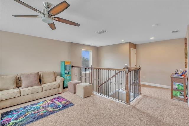 carpeted living area featuring recessed lighting, visible vents, ceiling fan, and baseboards