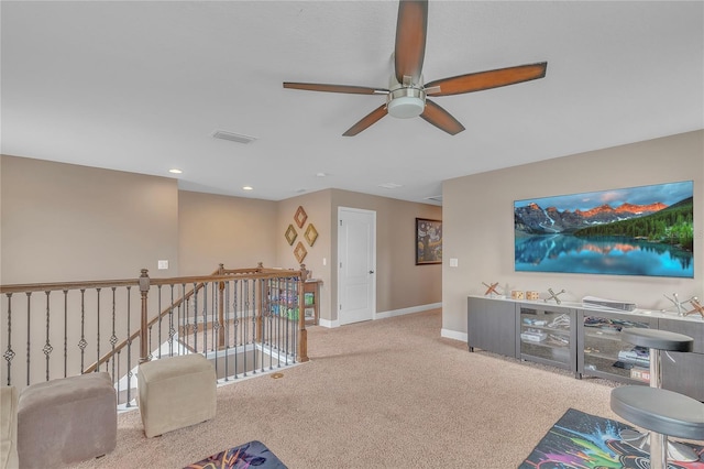 living area with carpet, visible vents, baseboards, and recessed lighting