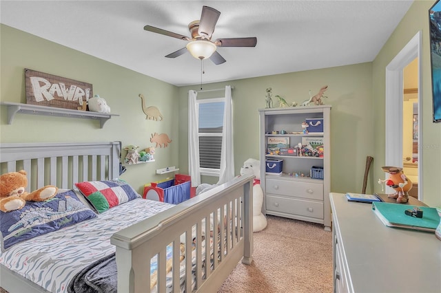 bedroom featuring light carpet and ceiling fan