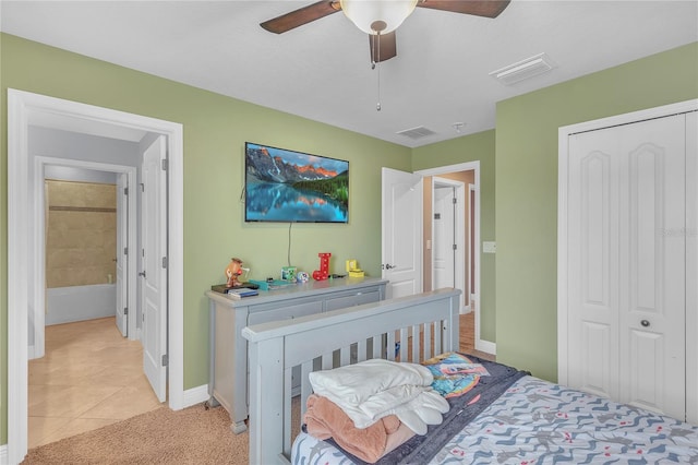 bedroom with light tile patterned floors, a closet, and visible vents