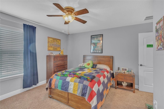 bedroom featuring baseboards, visible vents, ceiling fan, and light colored carpet