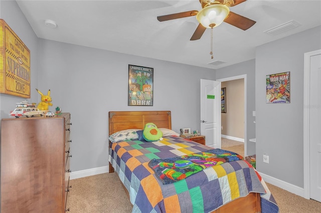 bedroom featuring a ceiling fan, visible vents, light carpet, and baseboards