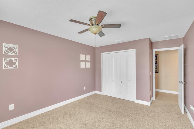 unfurnished bedroom with light carpet, a ceiling fan, visible vents, baseboards, and a closet