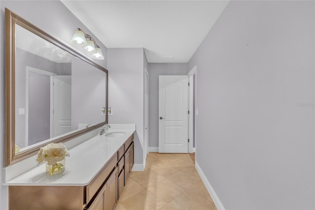 bathroom with tile patterned flooring, baseboards, and vanity