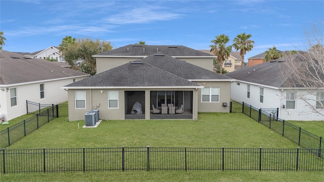 back of house with a fenced backyard, central AC unit, a lawn, and stucco siding