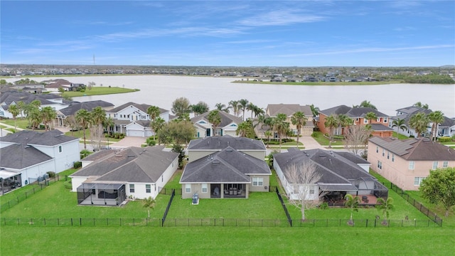 drone / aerial view featuring a water view and a residential view