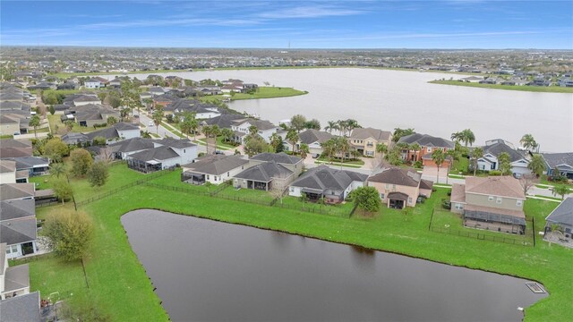 birds eye view of property with a water view and a residential view