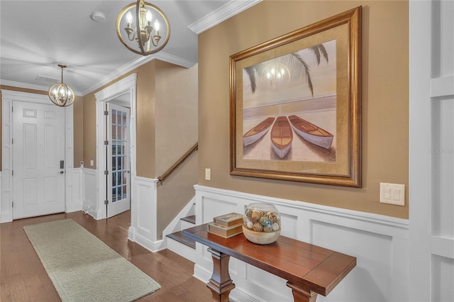 11330 Lake Lucaya Dr, Riverview, FL 33579 - foyer entrance with a wainscoted wall, ornamental molding, a decorative wall, and a chandelier