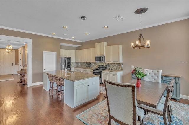 11330 Lake Lucaya Dr, Riverview, FL 33579 - kitchen with visible vents, decorative backsplash, a center island with sink, a chandelier, and stainless steel appliances