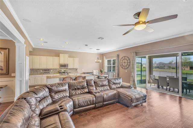 11330 Lake Lucaya Dr, Riverview, FL 33579 - living room featuring crown molding, ceiling fan, wood finished floors, and visible vents
