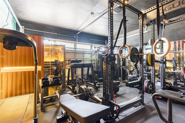 exercise room with a garage and a textured ceiling