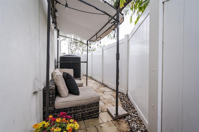 view of patio / terrace featuring cooling unit and a fenced backyard