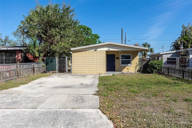 exterior space featuring a gate, fence, and concrete driveway