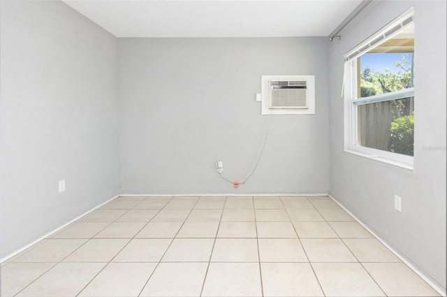 unfurnished room with an AC wall unit