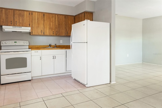 kitchen featuring light tile patterned floors, under cabinet range hood, white appliances, a sink, and light countertops