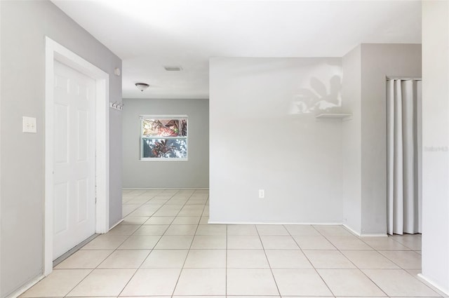 unfurnished room featuring light tile patterned flooring and visible vents