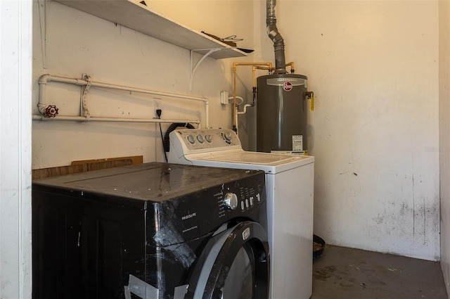 clothes washing area featuring water heater, laundry area, and washer and dryer