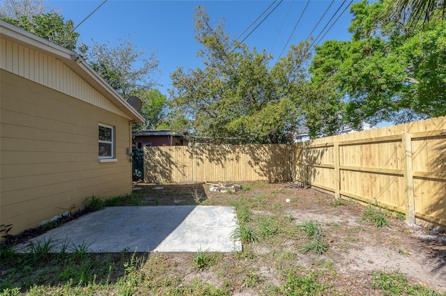 view of yard featuring a patio area and a fenced backyard