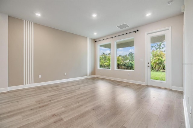 unfurnished room featuring recessed lighting, light wood-style floors, and baseboards