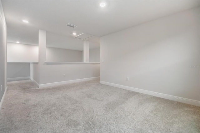 carpeted spare room featuring recessed lighting, visible vents, and baseboards