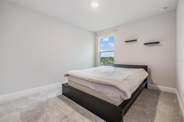 bedroom with baseboards and carpet floors