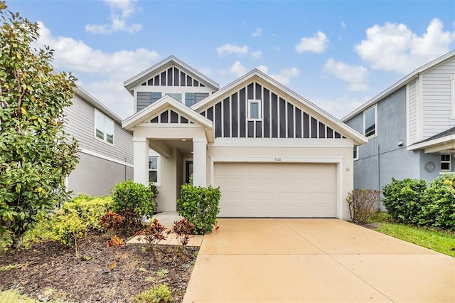 view of front of property with concrete driveway, a garage, and stucco siding