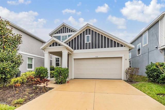 view of front of home with stucco siding, a garage, and driveway