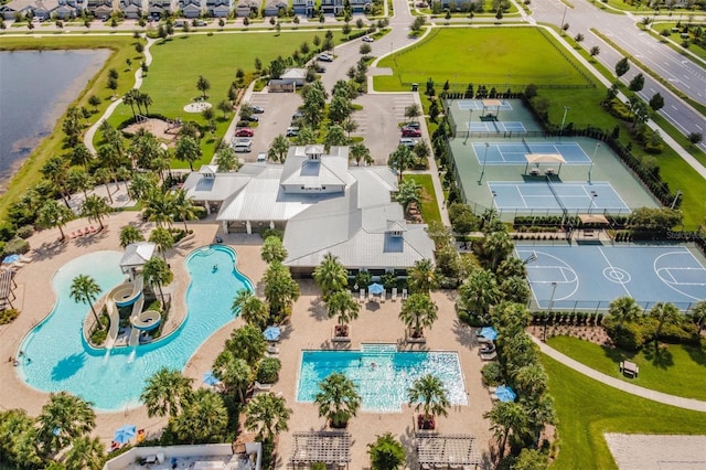 drone / aerial view featuring a residential view and a water view