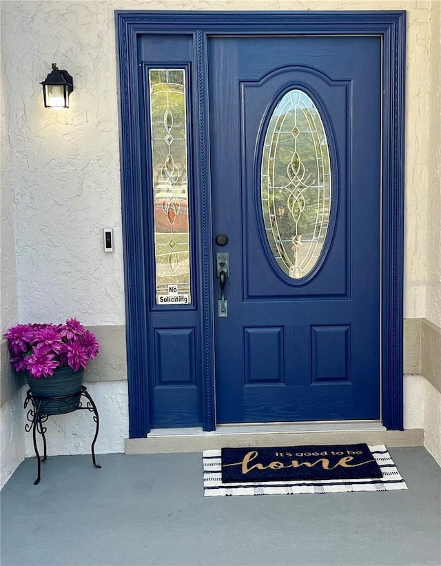 doorway to property with stucco siding