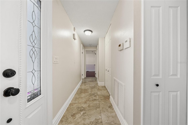 corridor with visible vents and baseboards