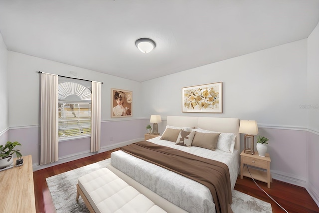 bedroom with baseboards and wood finished floors