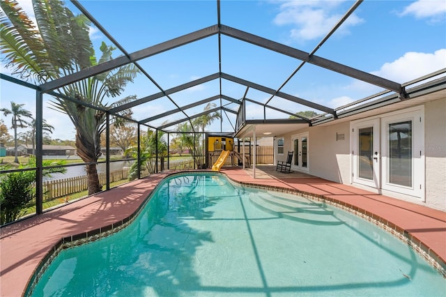 pool with french doors, a patio, a lanai, and fence