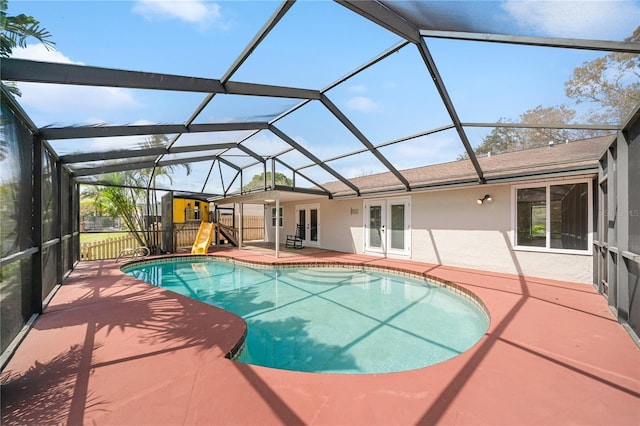 pool with a patio, french doors, and glass enclosure