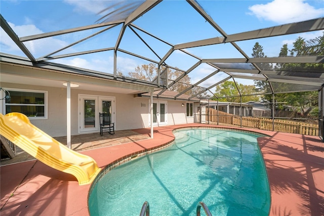 view of swimming pool featuring a fenced in pool, french doors, glass enclosure, a patio area, and fence