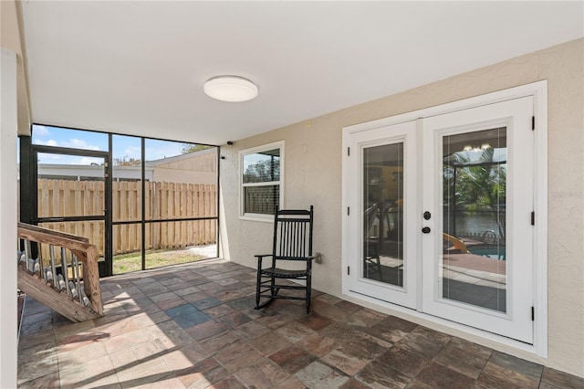 unfurnished sunroom featuring french doors